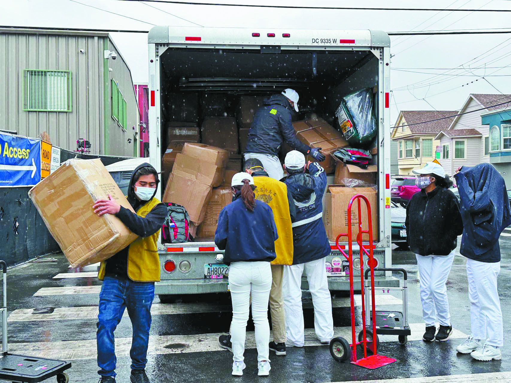 慈濟志工把禮物運到灣景區的帳篷營地，送給無家可歸者。