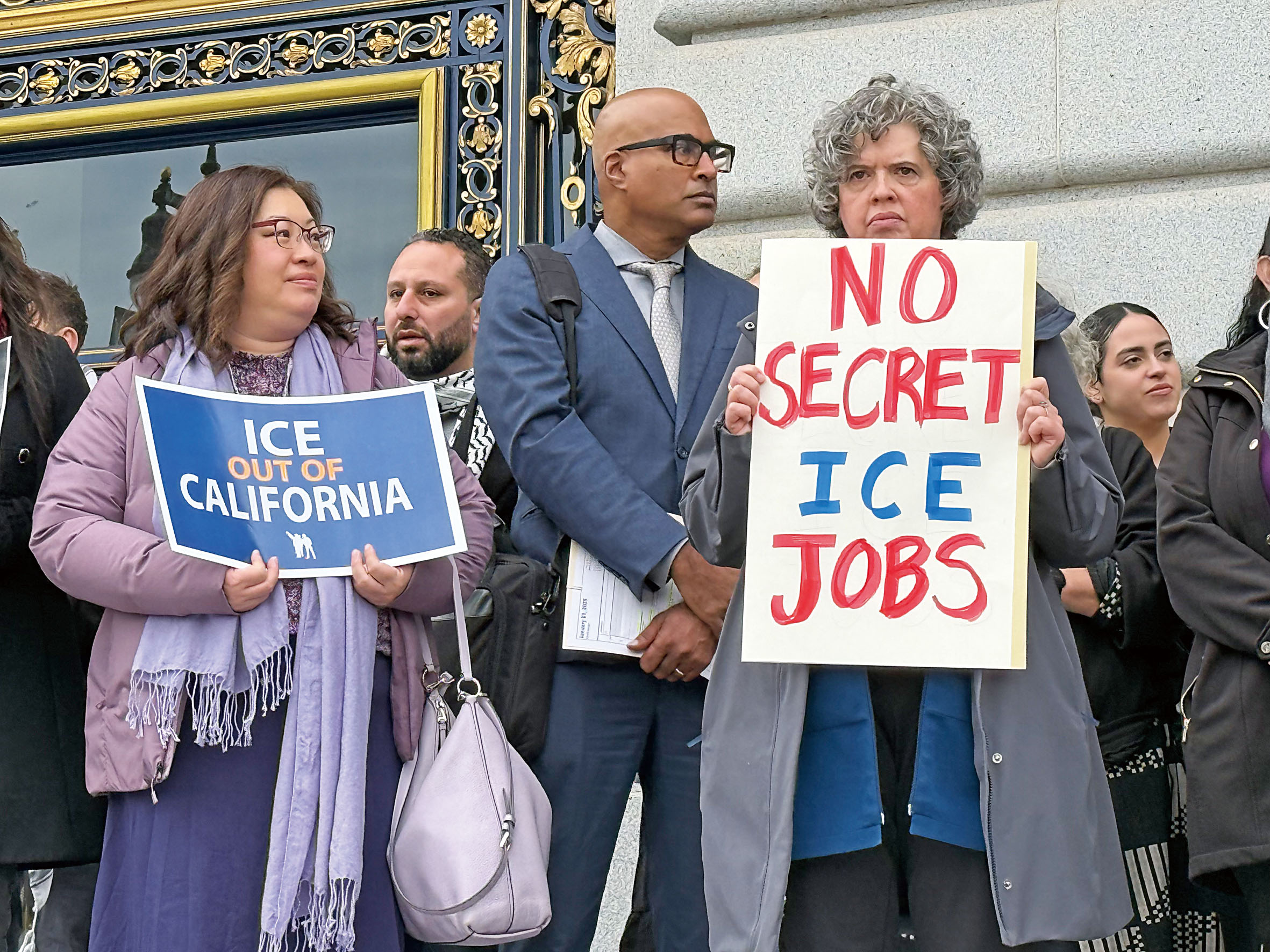 抗議民眾高舉標語表達訴求，標語寫著「一個臂章一個工作，不要從事ICE零工」及「不要秘密為ICE工作」，呼籲關閉警員下班兼職協助移民執法的漏洞。記者陳程威攝